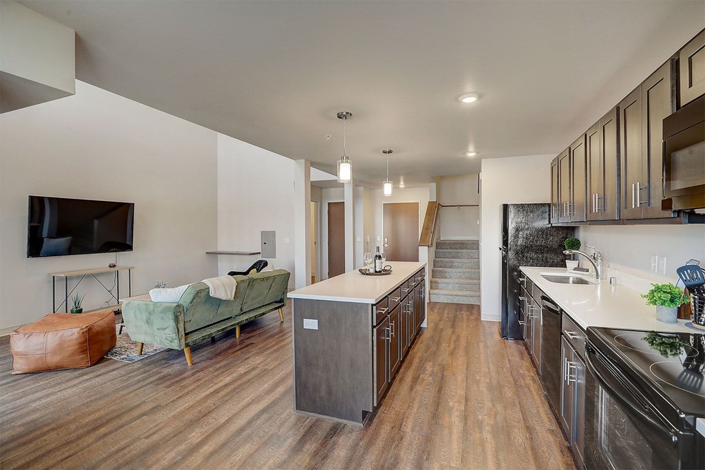 a kitchen with an island and a living room