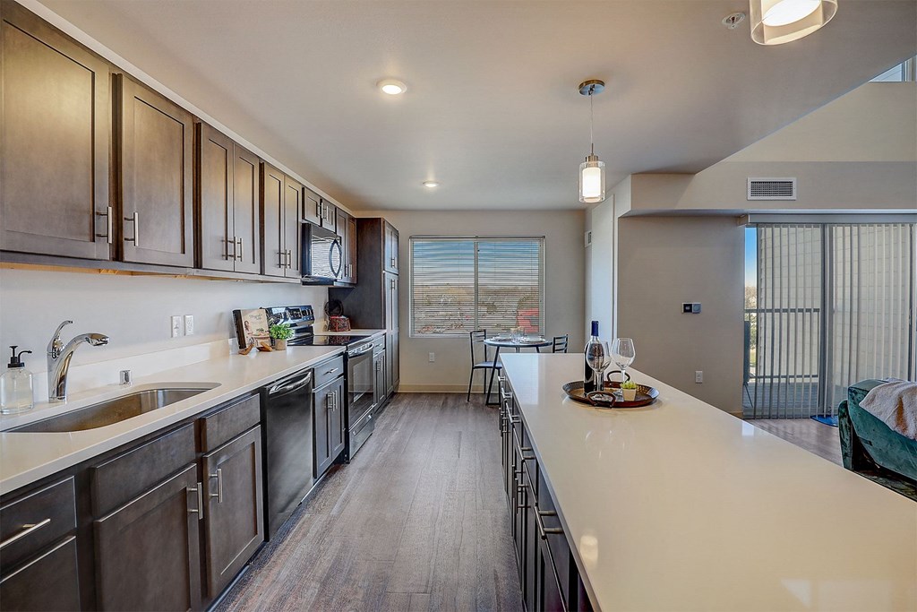 a kitchen with stainless steel appliances and a long counter top
