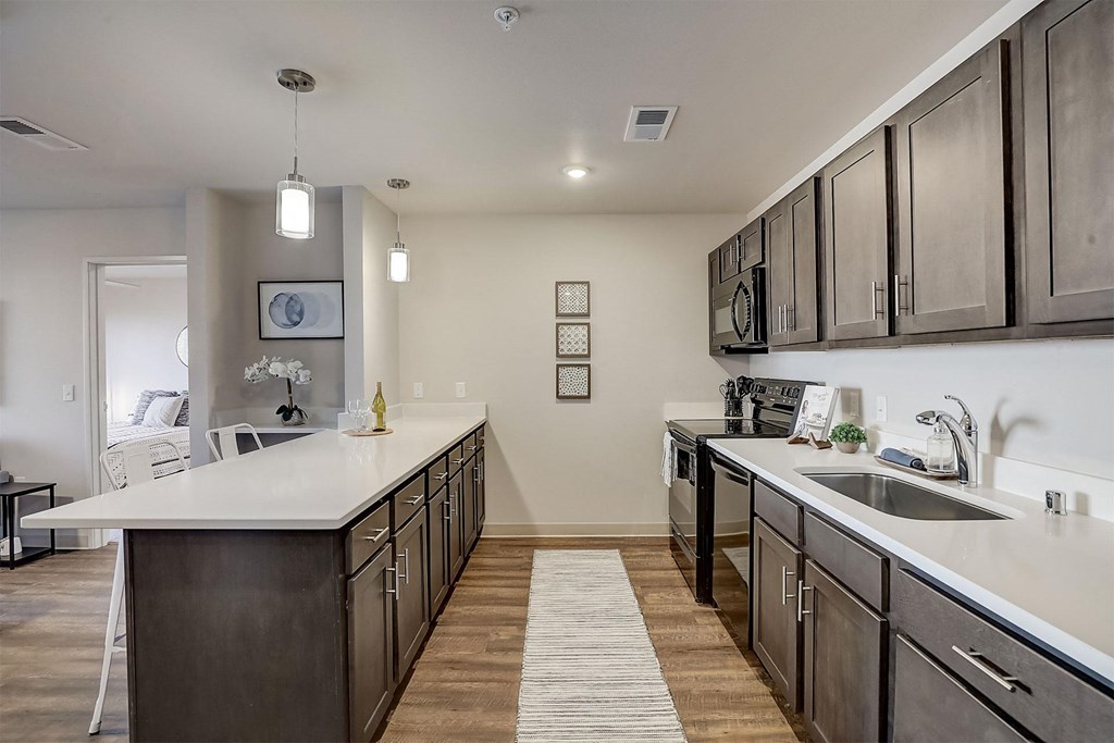 a large kitchen with stainless steel appliances and wooden cabinets