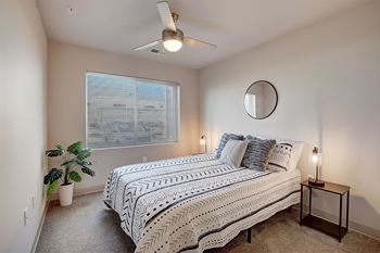a bedroom with a bed and a ceiling fan
