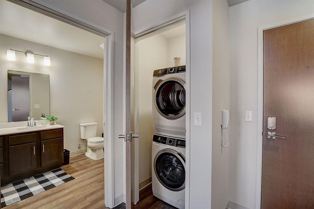 a bathroom and a closet with a washing machine and a dryer in it