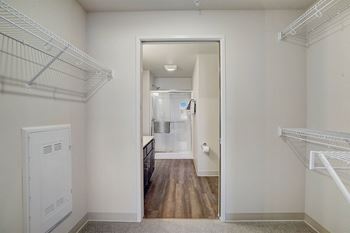 a bedroom with a closet and a door to a bathroom