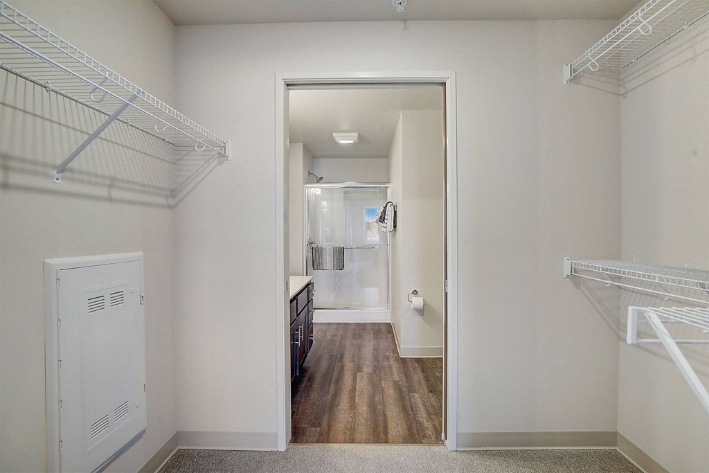 a bedroom with a closet and a door to a bathroom