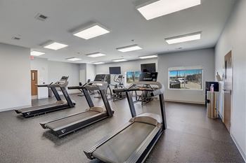 the gym has cardio equipment and treadmills in the wellness center