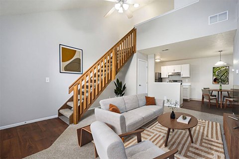 A living room with a couch, chairs, and a coffee table.