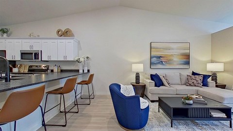 A modern living room with a blue chair and a grey couch.