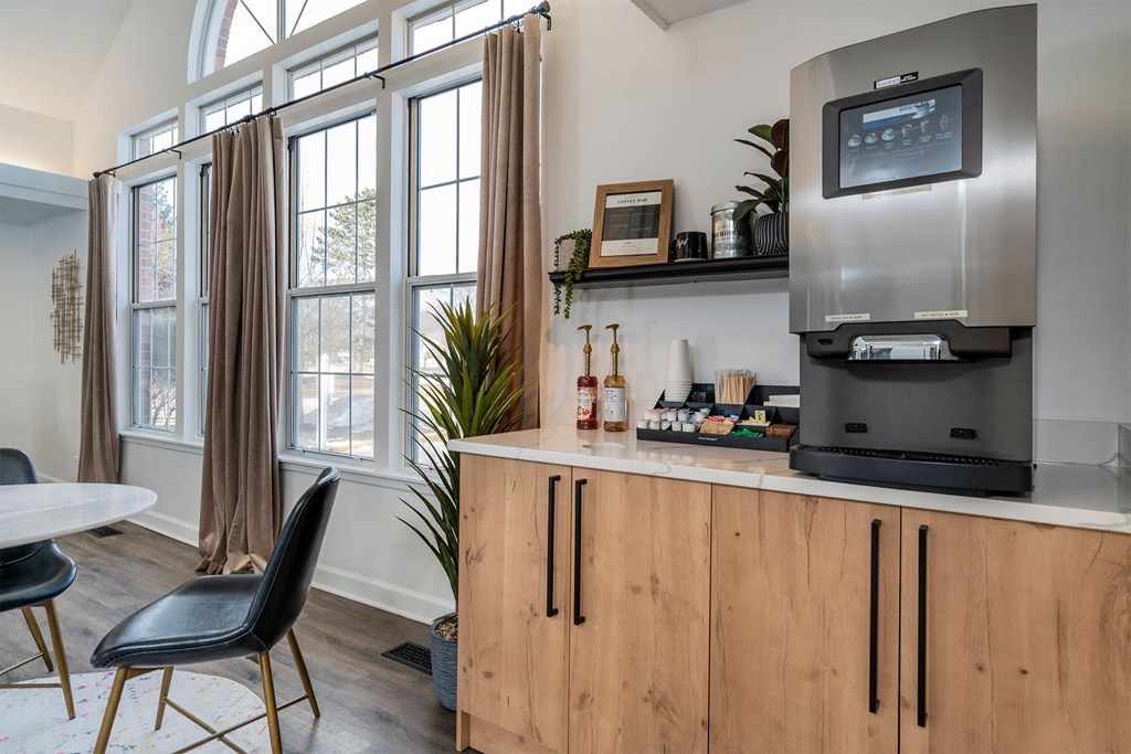a kitchen with a counter and a refrigerator and a window