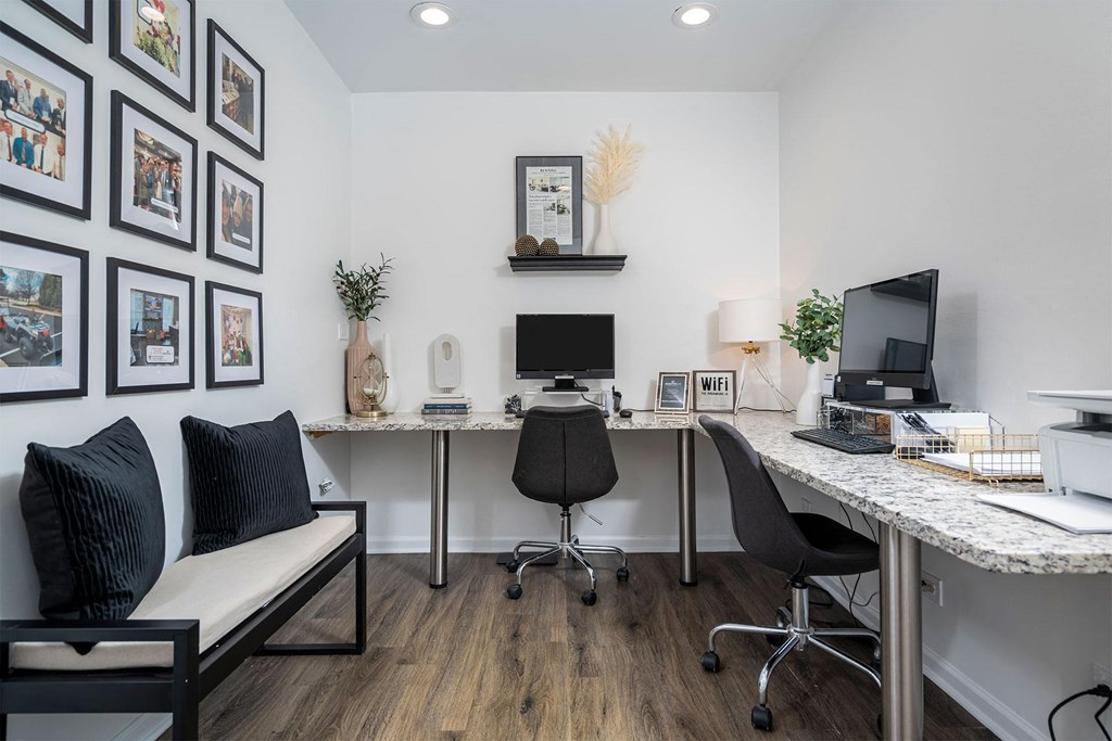 a home office with two desks and a computer