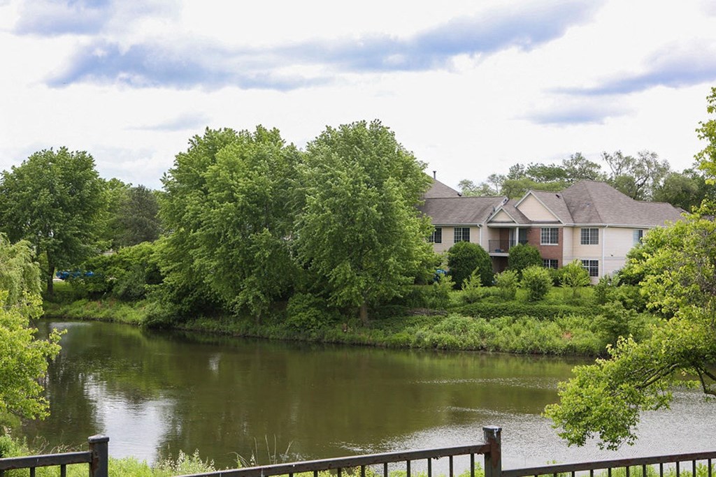 a house on the river next to a body of water