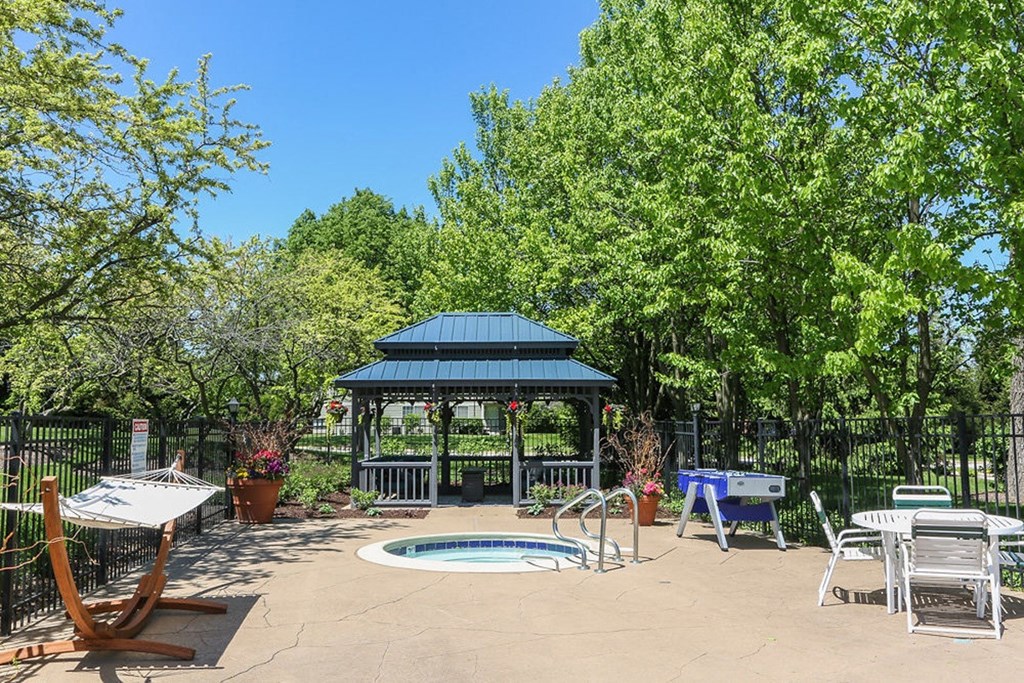 a patio with a pool and a gazebo