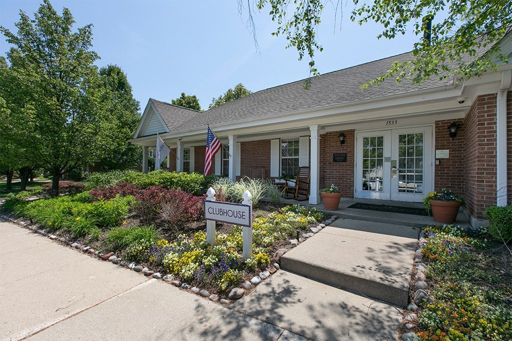 front view of the counseling center with a sign in front of it and a garden