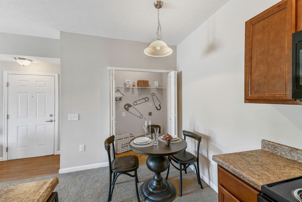 A kitchen with a table and chairs in the middle of the room.