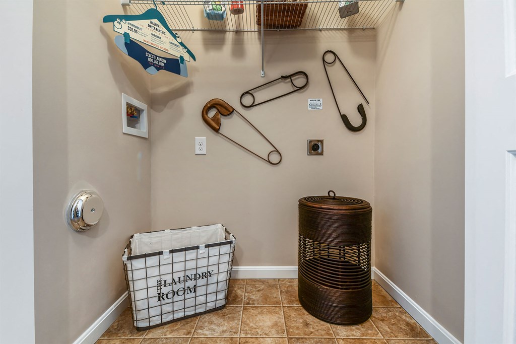A laundry room with a basket and a washing machine.