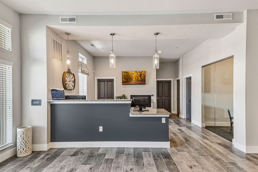 A reception area with a desk and a computer.