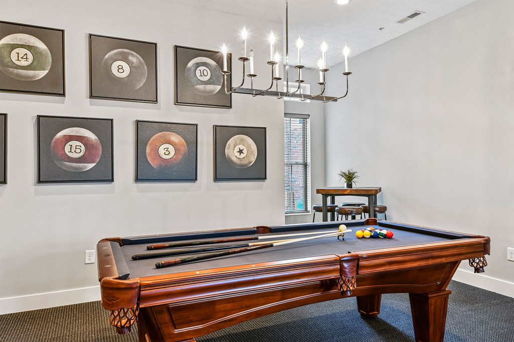 A pool table with a lighted billiard ball on it.