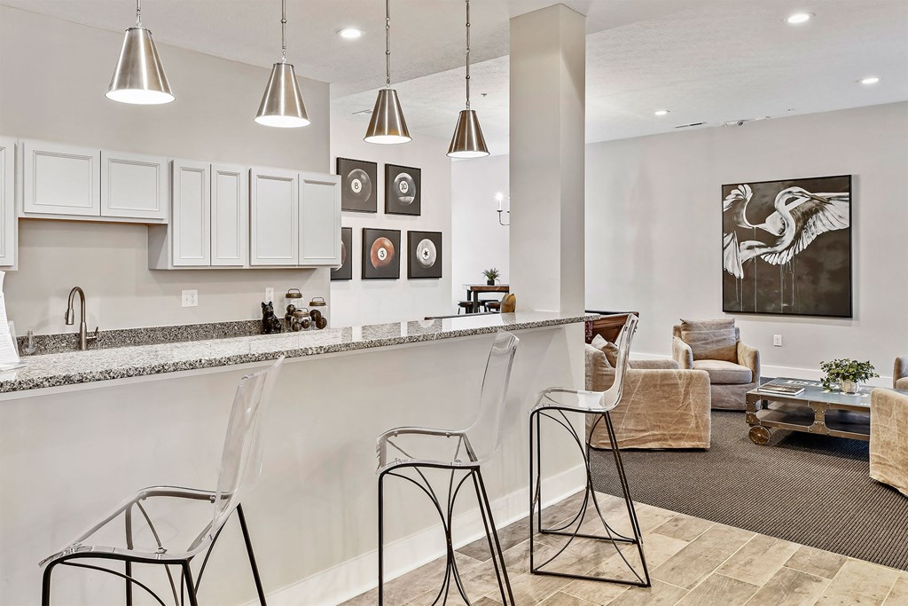 A kitchen with white cabinets and a grey countertop.
