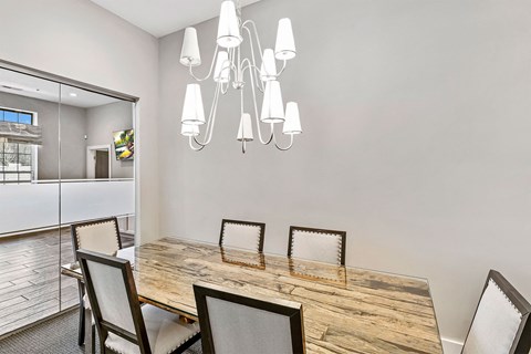 A dining room with a wooden table and chairs.