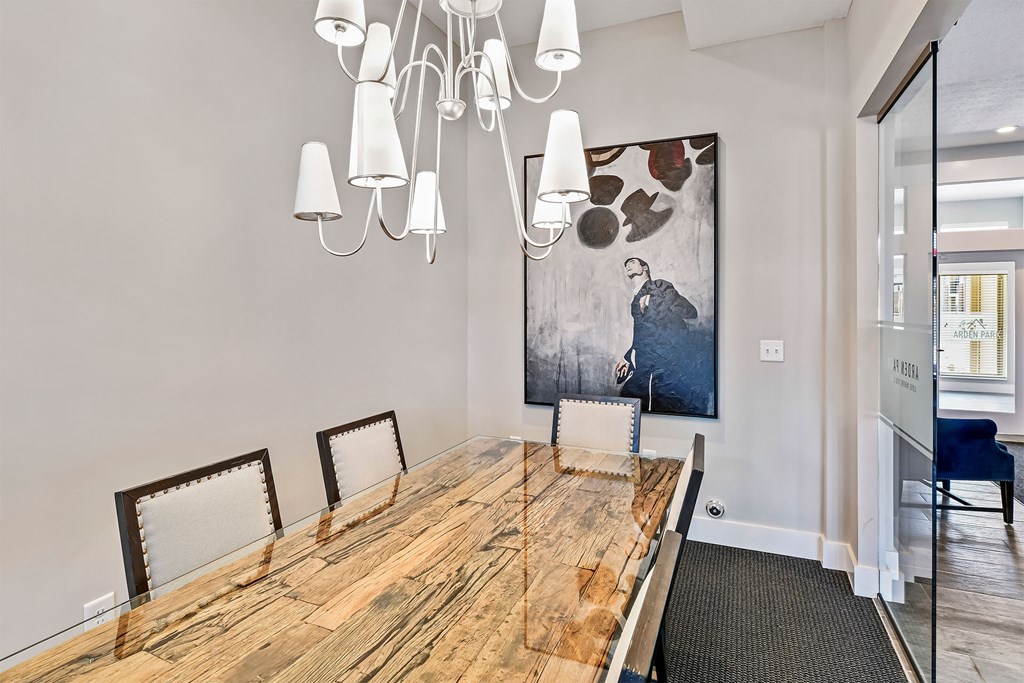 A dining room with a wooden table and chairs.