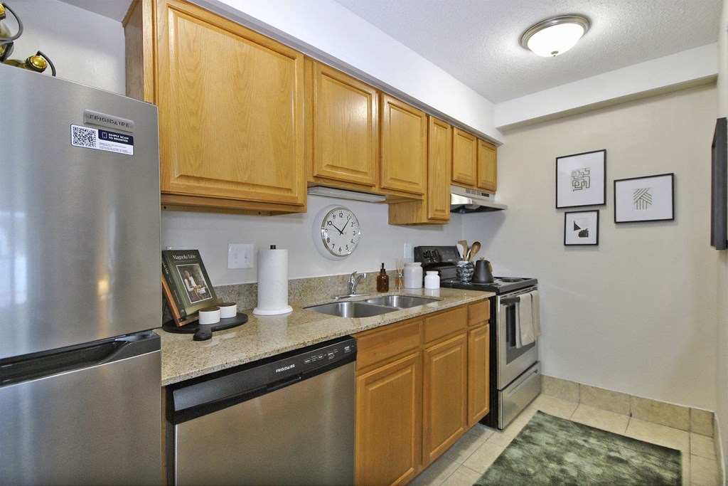 a kitchen with stainless steel appliances and wooden cabinets