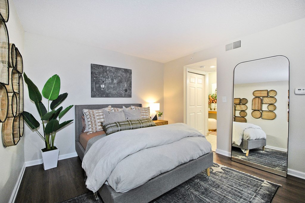 a bedroom with a bed and a mirror