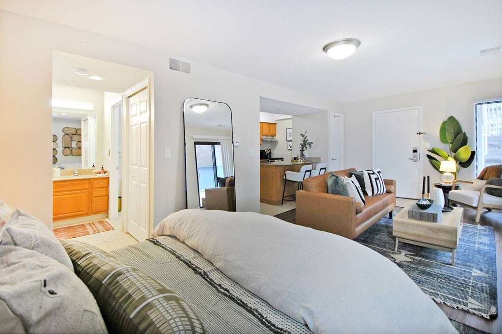 a bedroom with a bed and a living room