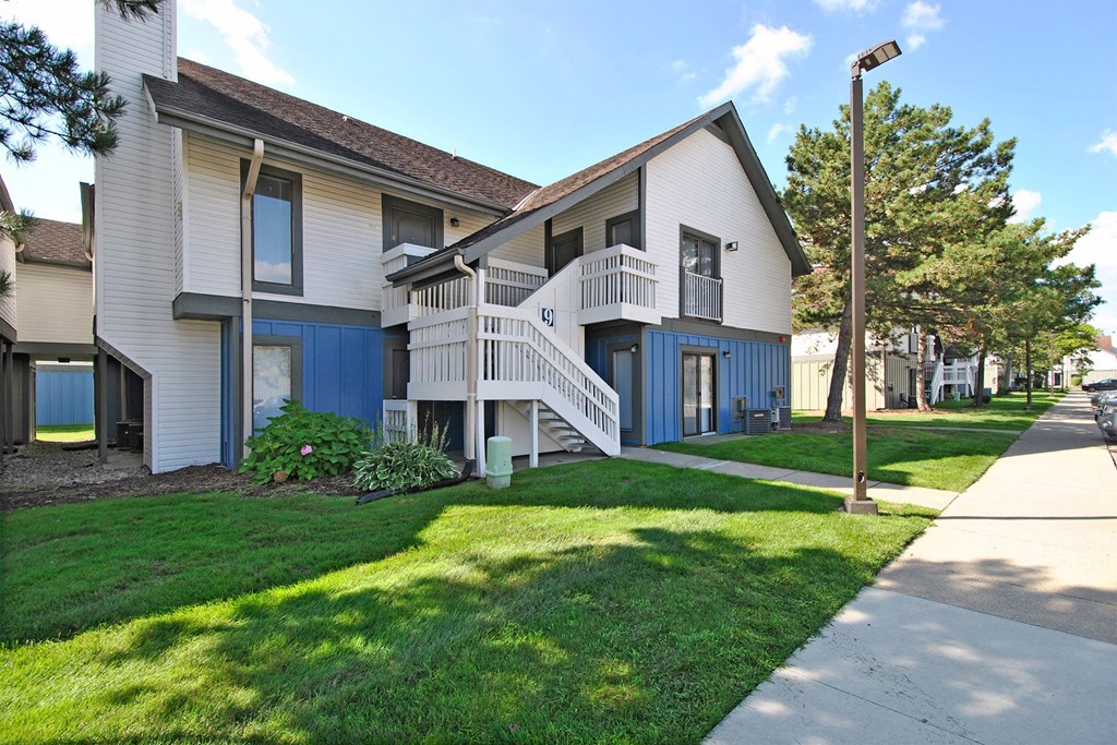 apartments located in a quiet neighborhood with a sidewalk