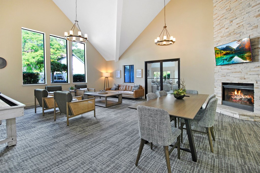 cloubhouse with a table and chairs and a fireplace