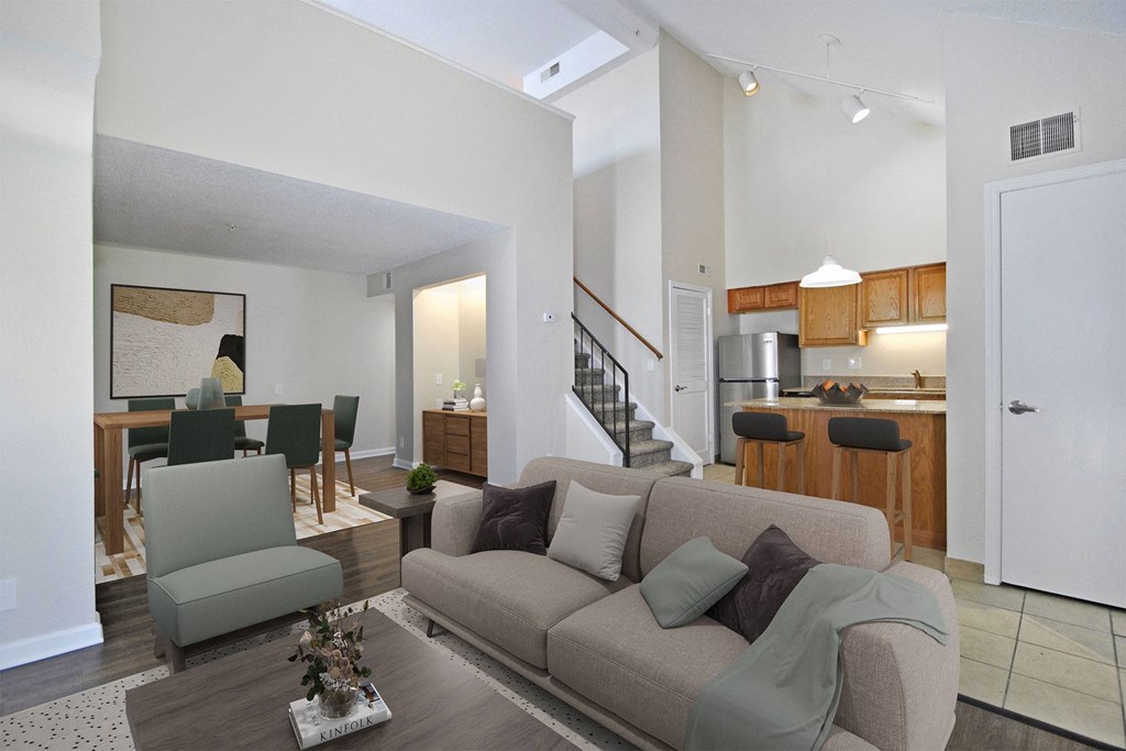 apartment living room with sofa and coffee table with kitchen in background
