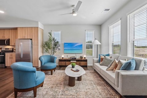 A modern living room with a blue chair and a grey couch.