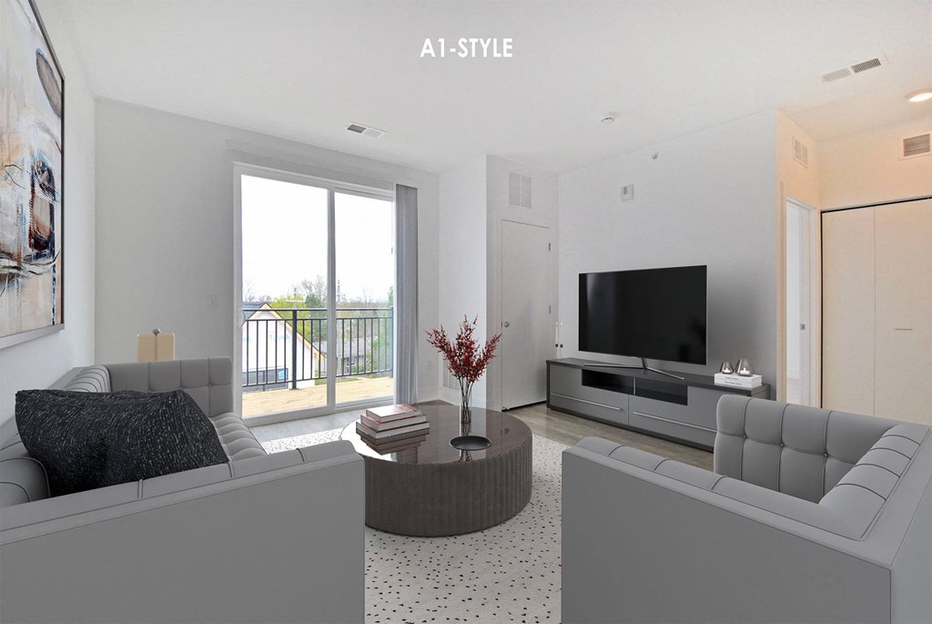 A modern living room with grey furniture and a flat screen TV.