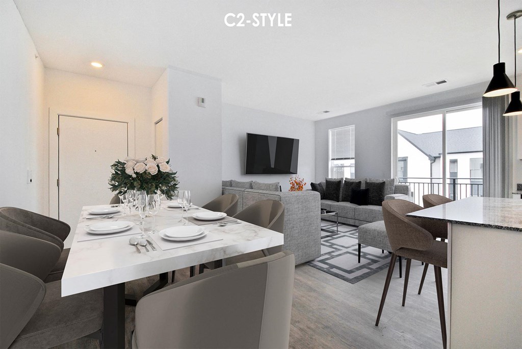A modern dining room with a white table and chairs.