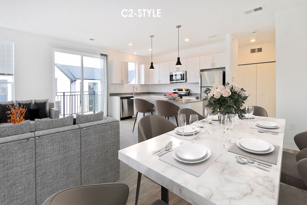 A modern dining room with a white marble table set for two.