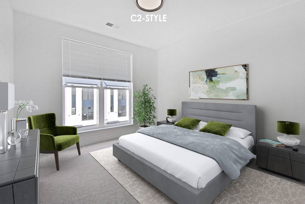 A modern bedroom with a large bed and a green chair.