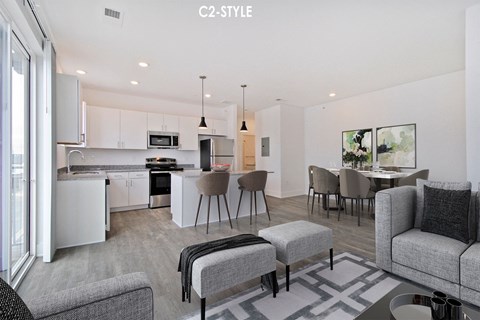 a kitchen and living room with a table and chairs