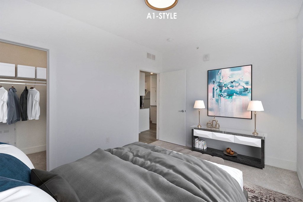 a master bedroom with a large bed and a bathroom