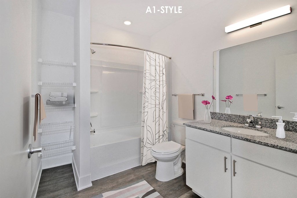a white bathroom with a shower toilet and sink