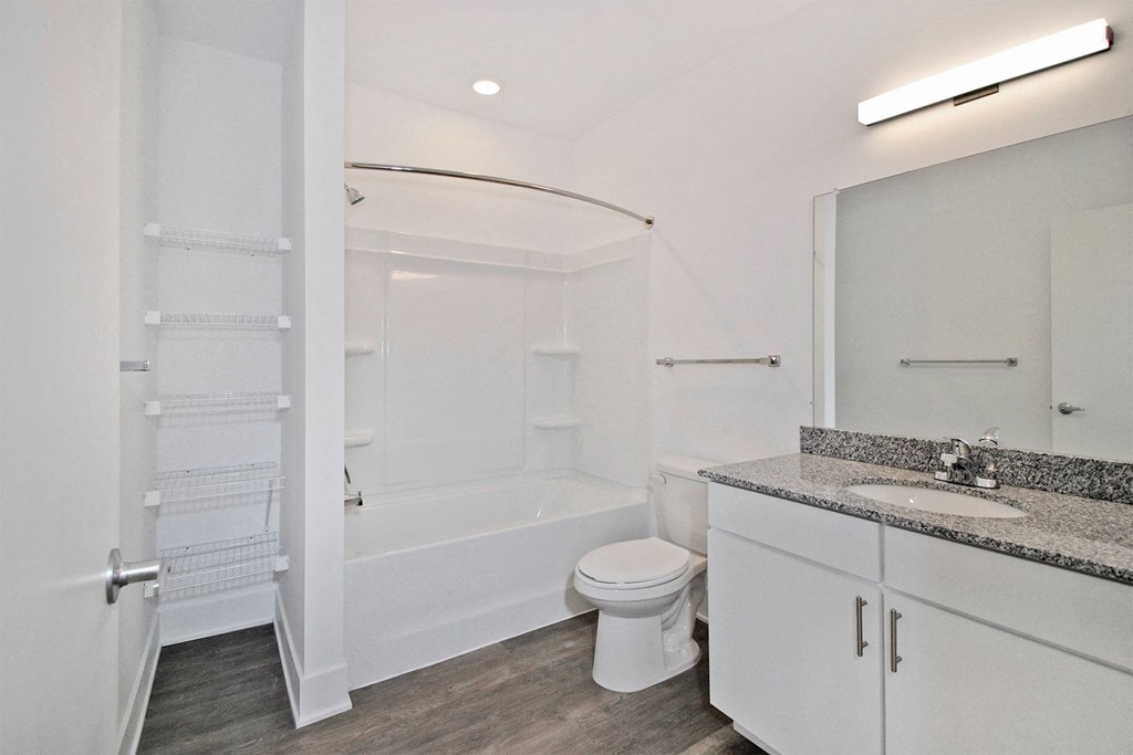 a bathroom with a shower toilet and sink and a mirror