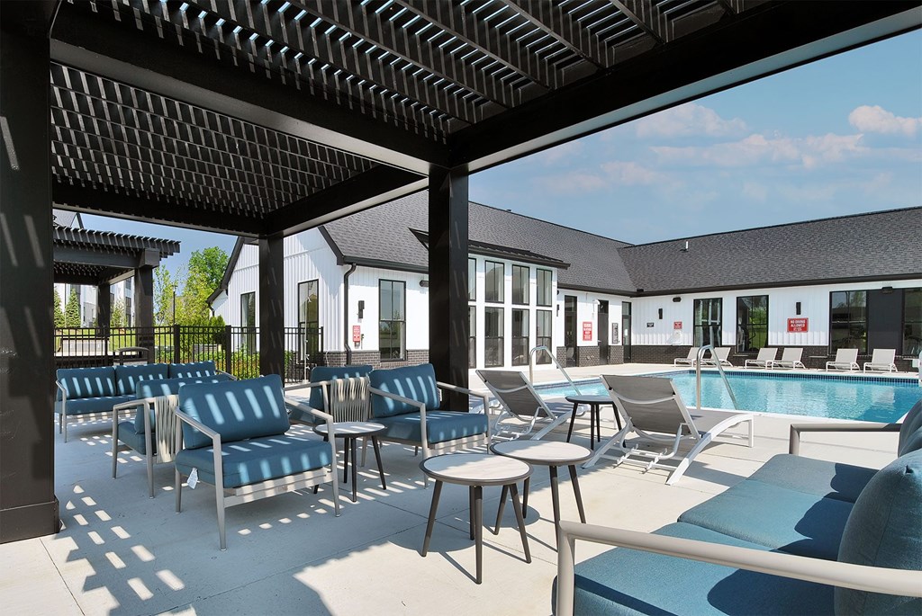 A pool area with chairs and tables is shown.