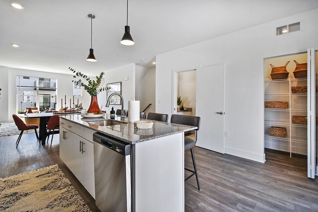 a kitchen with an island and a dining room with a table