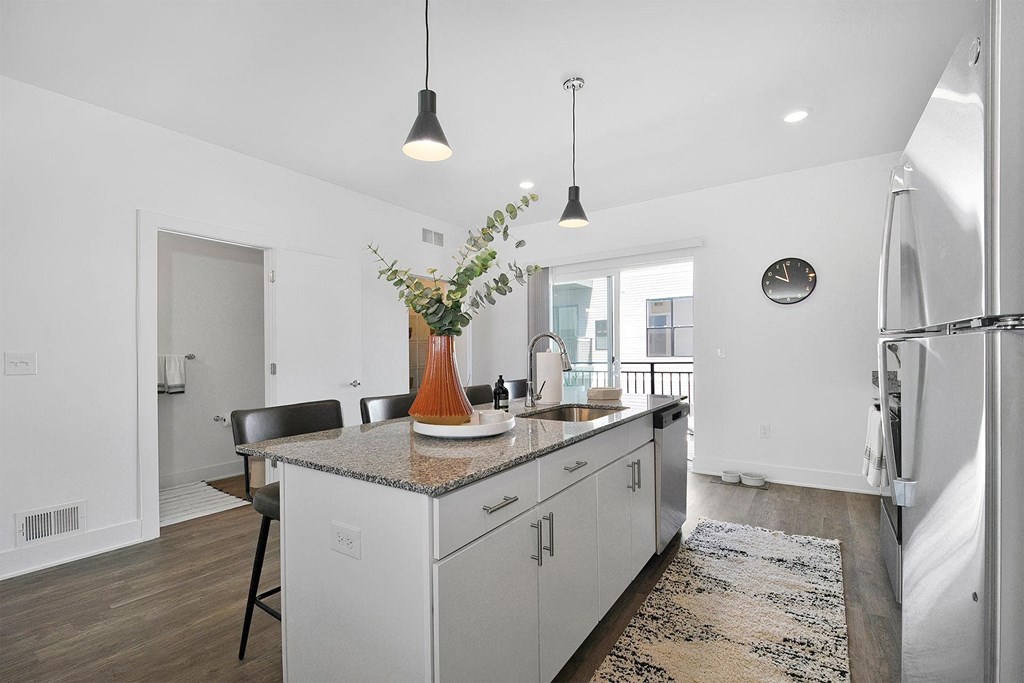 a kitchen with a counter top and a refrigerator