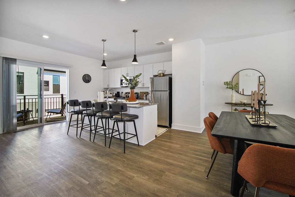 a kitchen and dining room with a table and chairs