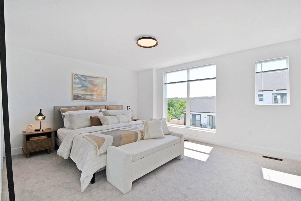 a bedroom with a couch and a bed