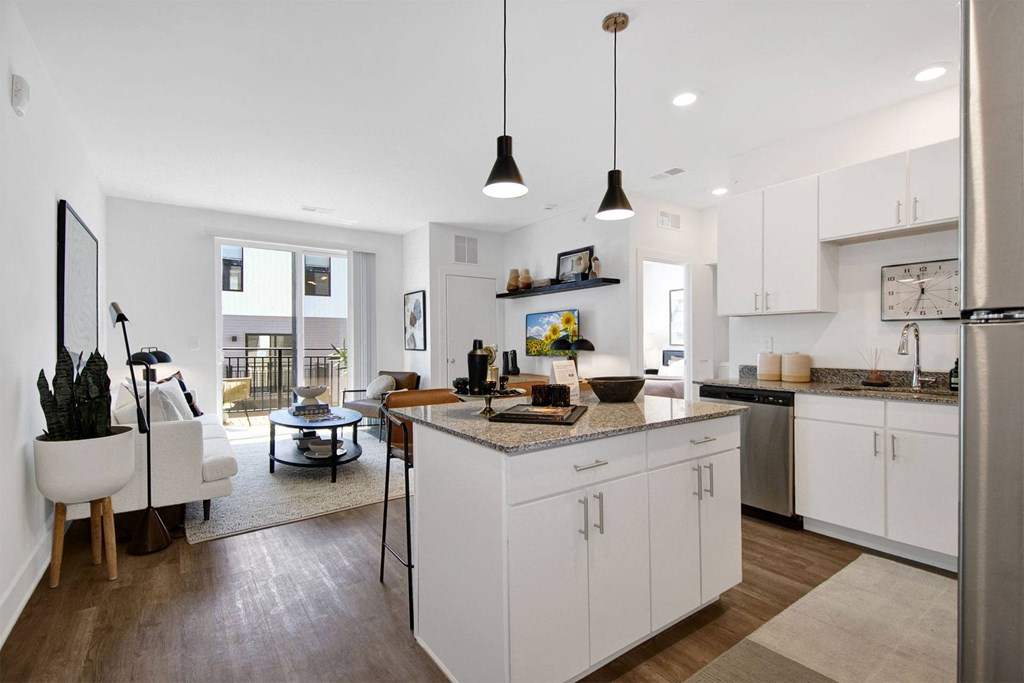 a kitchen with an island and a living room