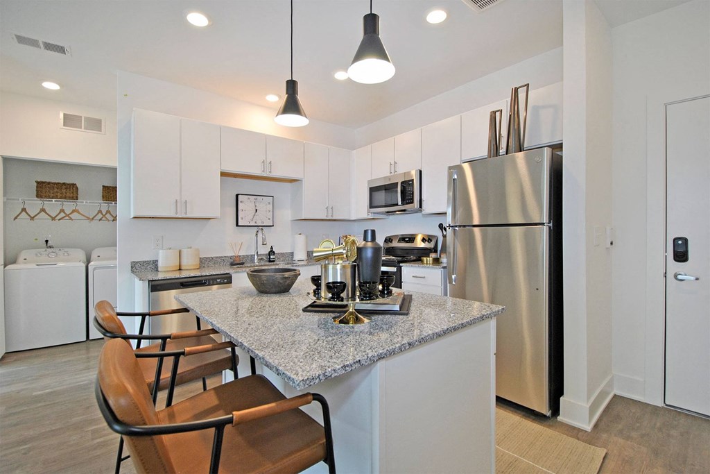 a kitchen with stainless steel appliances and a granite counter top