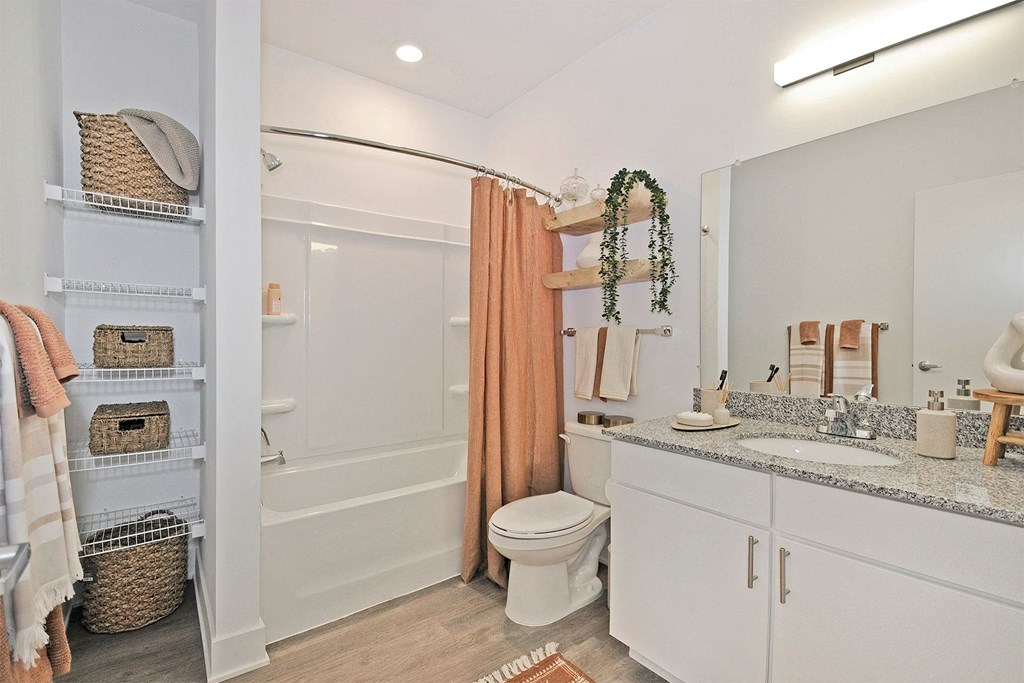 a bathroom with a shower and a sink and a toilet