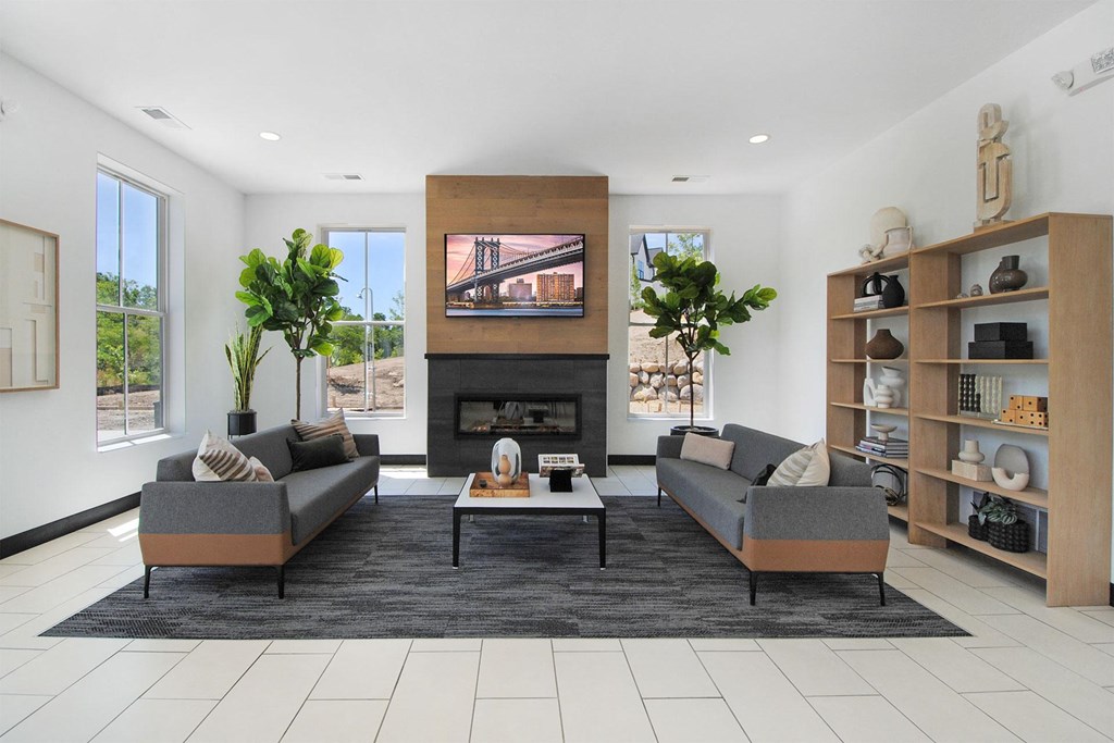 a living room with couches and a table and a fireplace