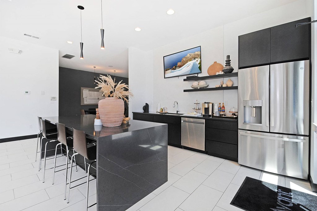 a kitchen with a large island and stainless steel appliances