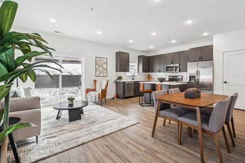 A modern kitchen with a dining table and chairs.