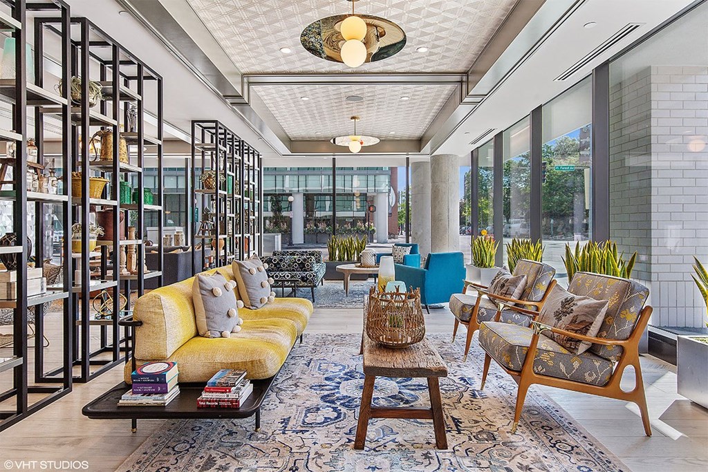 a living room filled with furniture and large windows