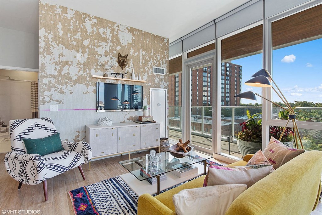 a living room with a large window and a view of the city